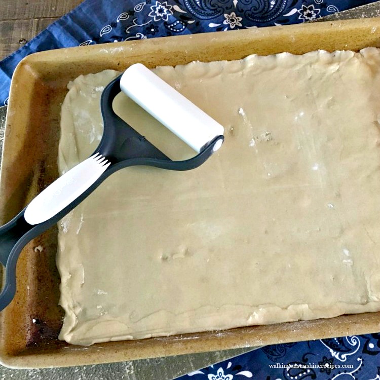 Roll out sugar cookie dough with pastry roller