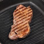 Grilled steak in cast iron pan