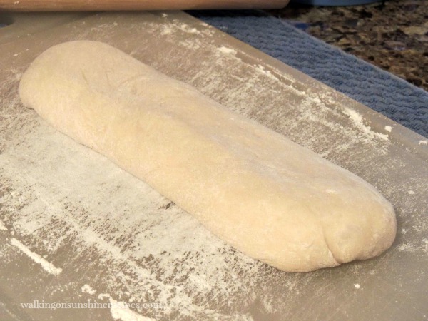 Unbaked Calzone on cutting board .