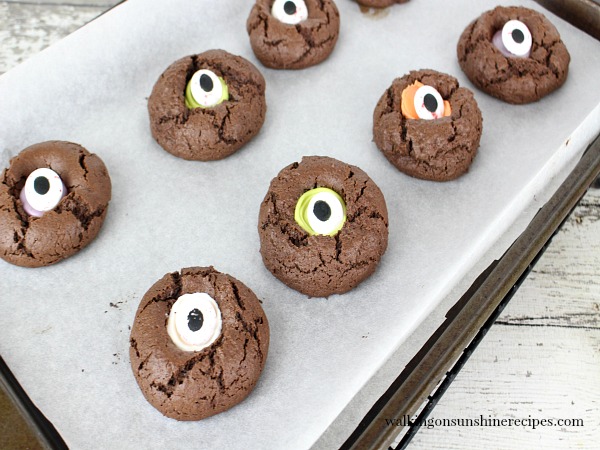 Halloween Thumbprint Cookies on baking tray with eye candies.