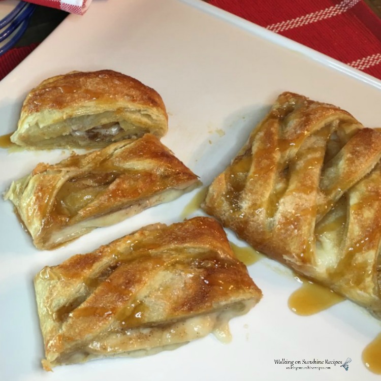 Apple Puff Pastry Braid drizzled with caramel sauce on white plate