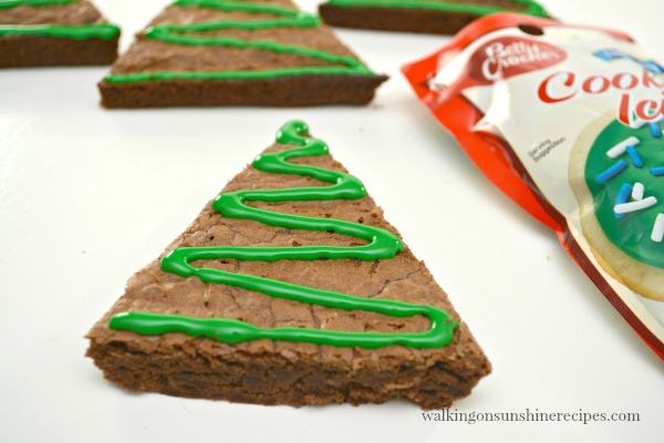 Add squiggly lines to the triangle shaped brownies for Christmas Tree Candy Cane Brownies from Walking on Sunshine Recipes