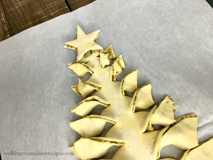 Christmas Tree Puff Pastry with pesto sauce - Savory puff pastry filled with pesto sauce and then shaped into a Christmas tree makes the perfect appetizer. Closeup of Christmas Tree Puff Pastry with Star from Walking on Sunshine Recipes