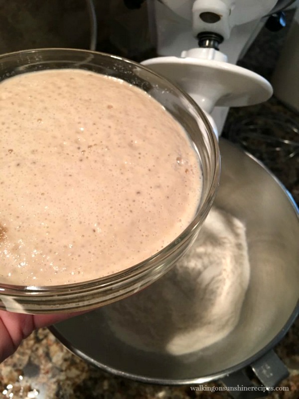 Adding the yeast to the flour for French Bread Baguettes with white Kitchen Aid Mixer