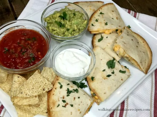 Cheesy Chicken Quesadillas on white platter with homemade salsa from Walking on Sunshine Recipes 