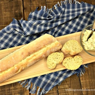 Homemade French Baguette with Garlic Butter on Bread Board