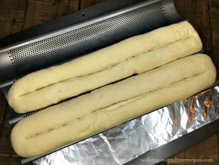 Make a shallow cut down the center of each unbaked loaf of bread dough for French Baguettes