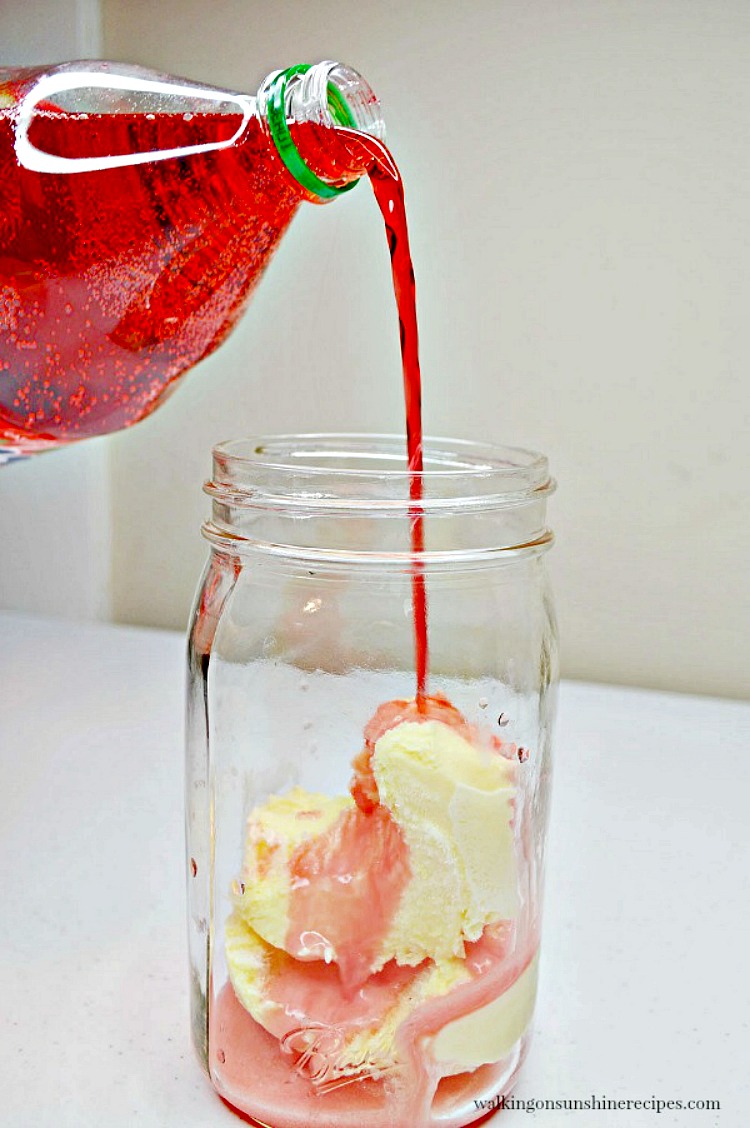 Pour Strawberry Soda on top of Vanilla Ice Cream in Mason Jar