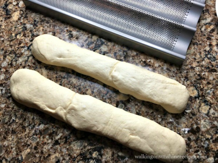 Shape the bread dough for French Baguettes and place in long baking pans. 
