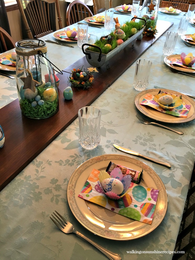 Table set with china, crystal and Grass Centerpiece for Easter. 
