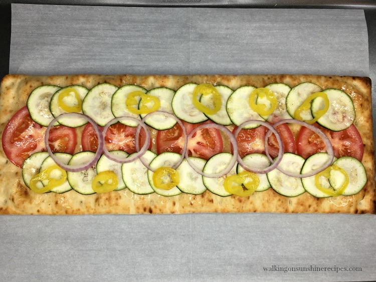 Layer Tomatoes, Zucchini and Red Onion on Flatbread Pizza