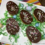 Chocolate Peanut Butter Eggs with confetti and plastic eggs on platter from Walking on Sunshine Recipes