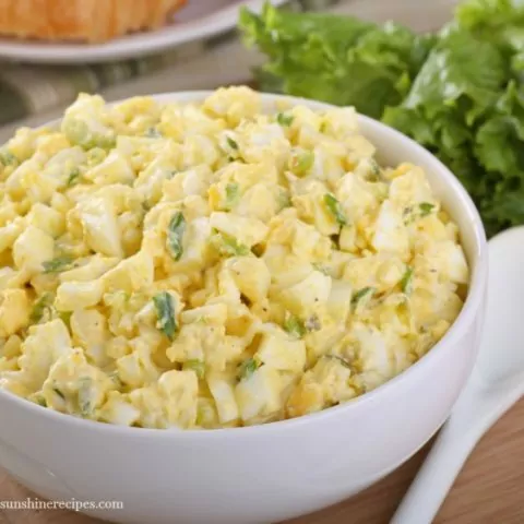 Egg Salad with Leftover Easter Eggs in white bowl with croissants from Walking on Sunshine Recipes
