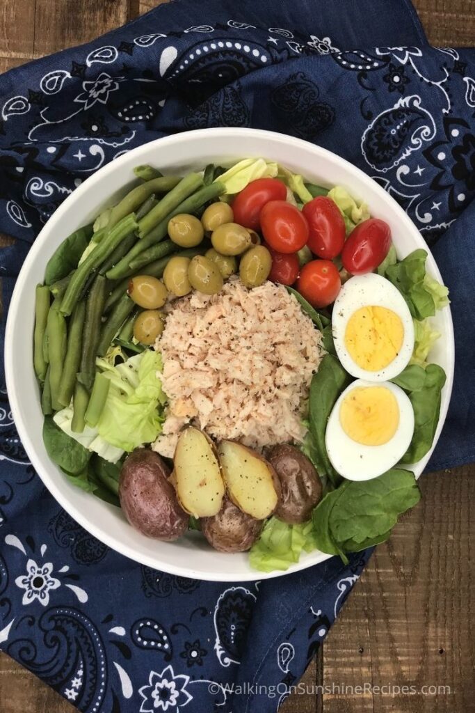 Tuna salad with boiled eggs, olives and tomatoes. 