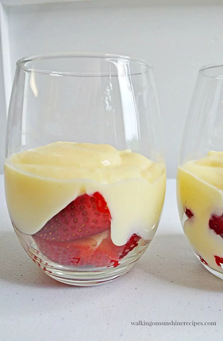 Add the pudding to the top of the strawberries for the Cheesecake Pudding Parfaits 