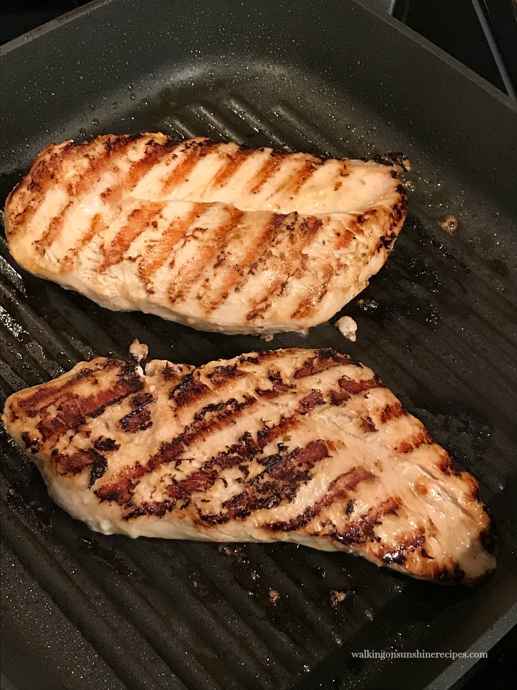 Grilled chicken cooking in Lodge Cast Iron Grill Pan. 