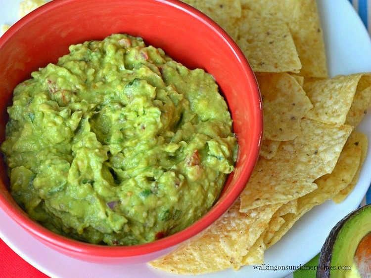 Homemade Guacamole in red bowl with chips from Walking on Sunshine Recipes