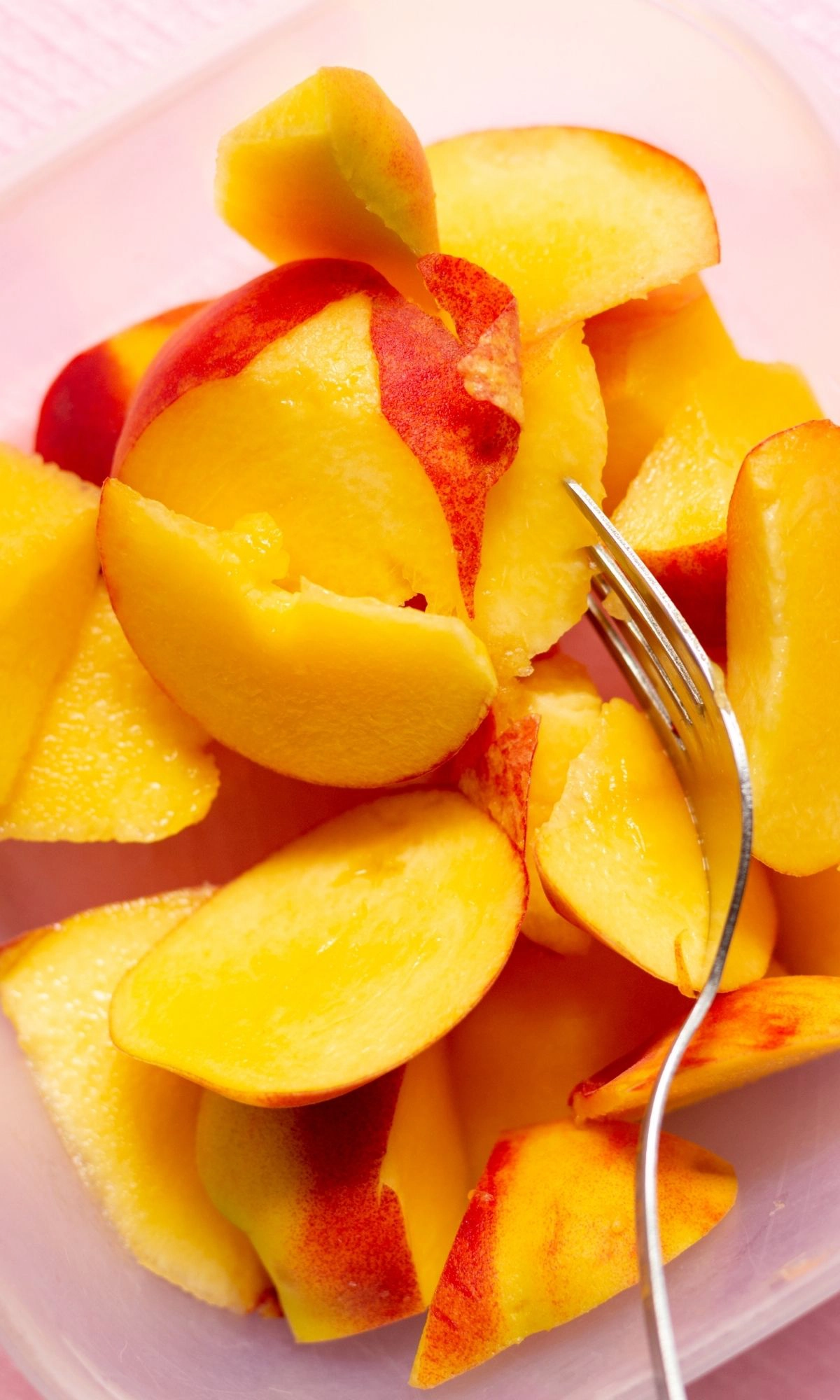 Sliced peaches with fork. 