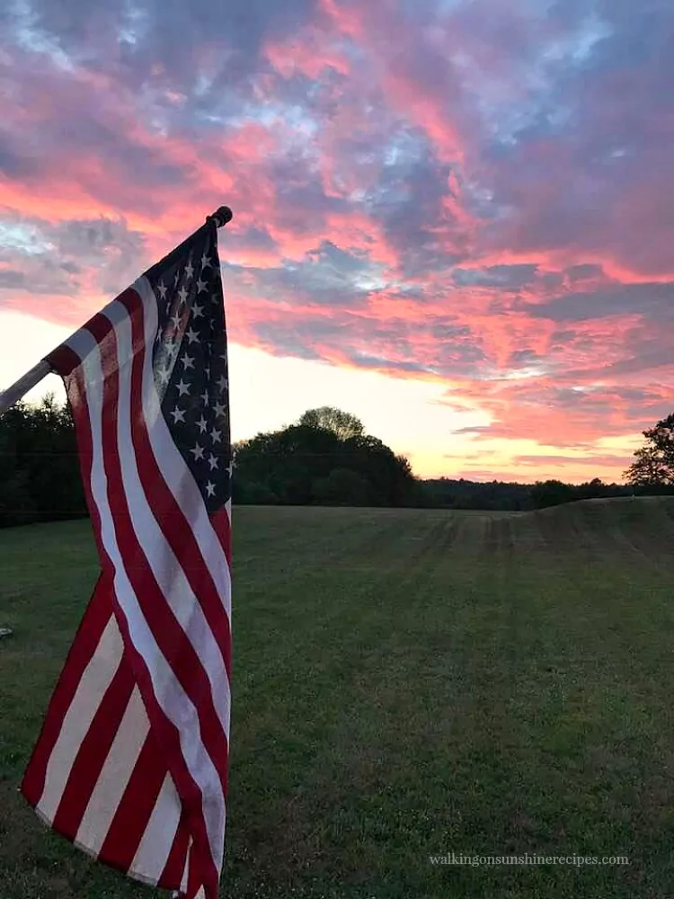 The View from our Summer Back Porch as the sun sets with American Flag. 