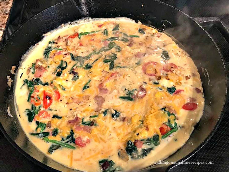 Add the eggs to the Spinach Bacon Cheese Frittata and place in oven. 