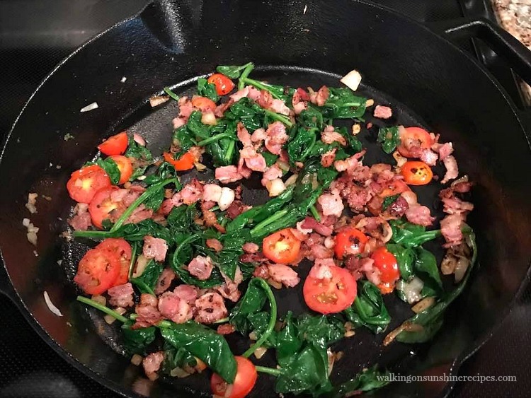 Add the bacon back to the cast iron pan and combine with tomatoes and spinach. 