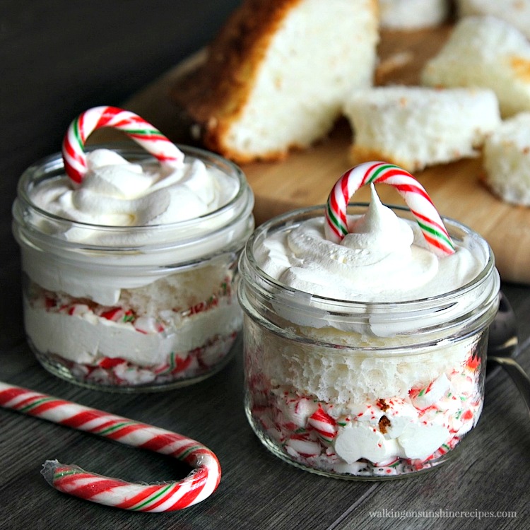 2 mason jars with angel food cake, whipped cream and cane canes. 