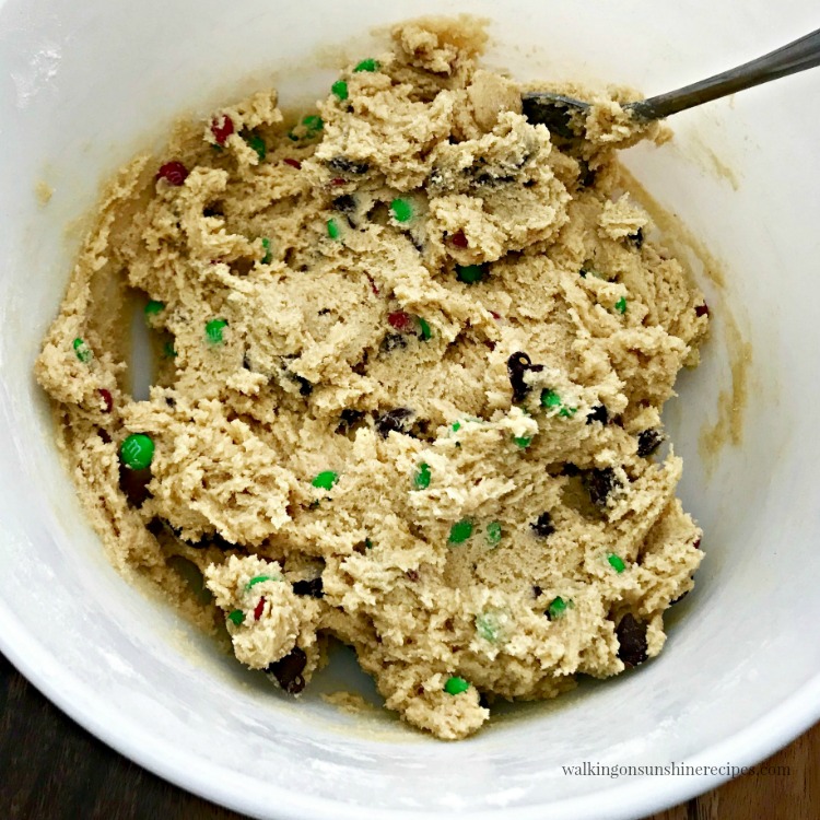 M&M Chocolate Chip Cookies are soft with crispy edges and full of flavor and will make the perfect homemade cookie gift for the holidays. M&M Chocolate Chip Cookie dough in white mixing bowl.