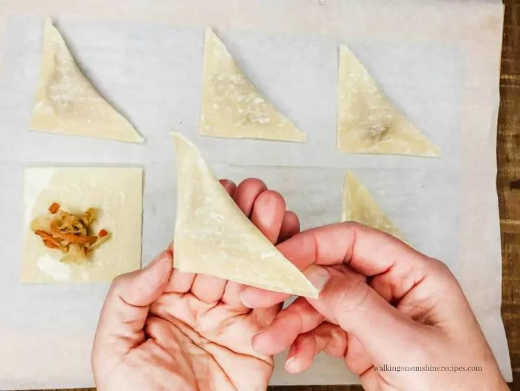 Fold the Wonton Wrappers in half to form triangles for Air Fryer Wontons Appetizers.