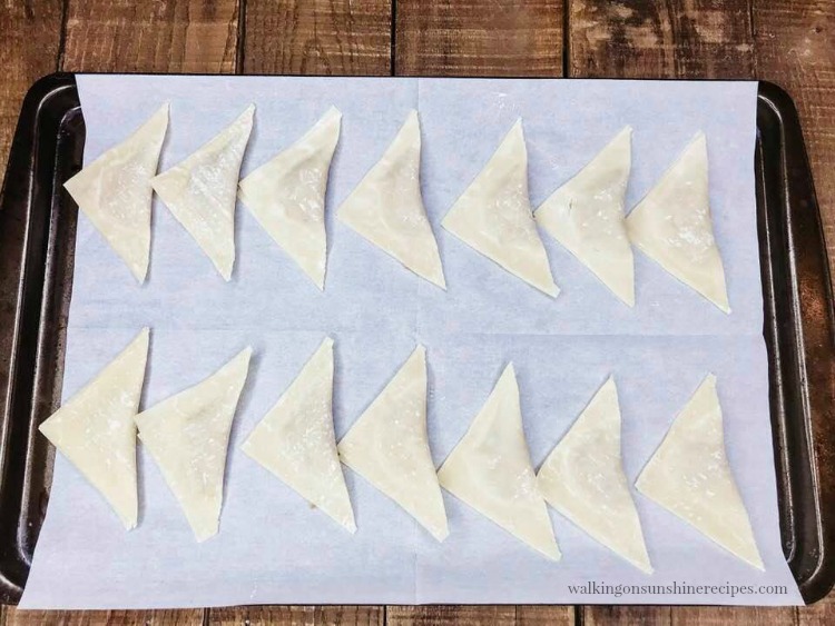 air fryer wonton wrapper recipes on parchment paper baking tray. 

