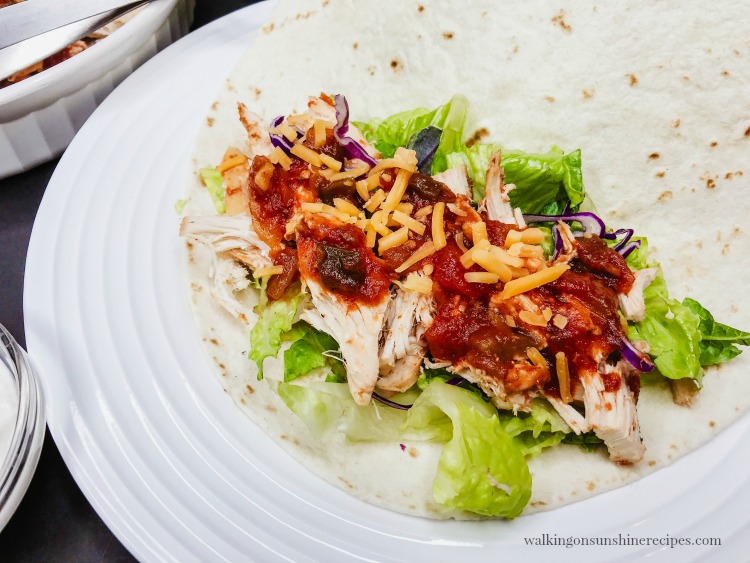 Crock Pot Salsa Chicken on plate with flour tortilla and lettuce