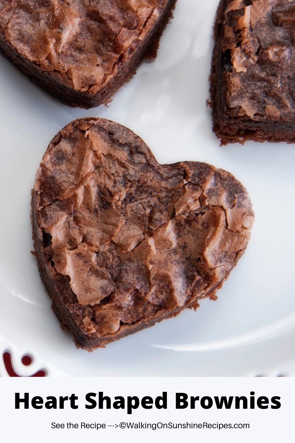 brownies cut into heart shapes on white plate. 