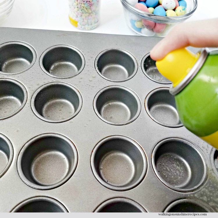 No Bake Rice Krispie Nests topped with mini chocolate robin eggs are a cute treat that is perfect for the Easter holiday. Spray non-stick cooking spray into muffin pan