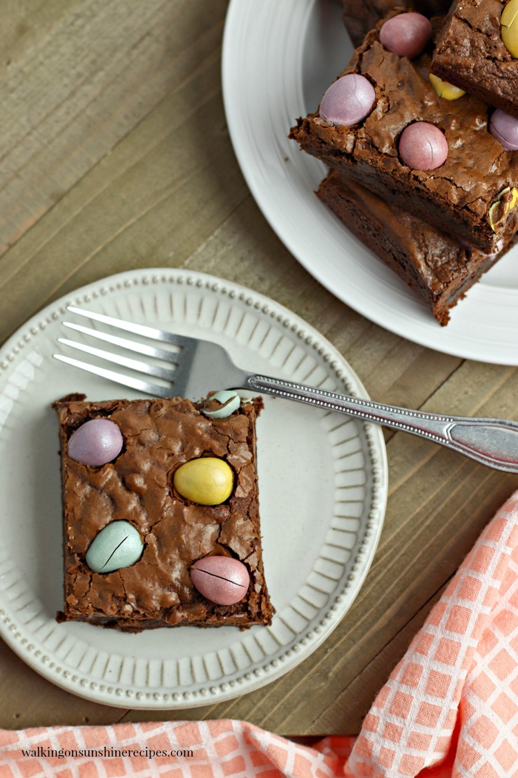 Chocolate Cadbury Egg Brownies from Walking on Sunshine Recipes Chocolate Cadbury Egg Brownies on white plates with forks.