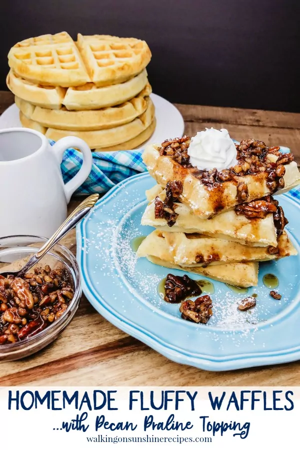 praline waffles on blue plate with homemade whipped cream. 