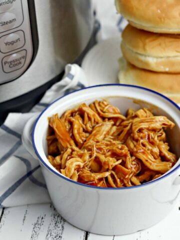 Instant Pot BBQ Chicken in bowl with rolls