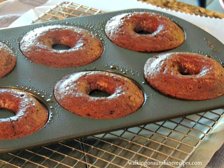 Chocolate Donuts in donut pan baked on wire rack