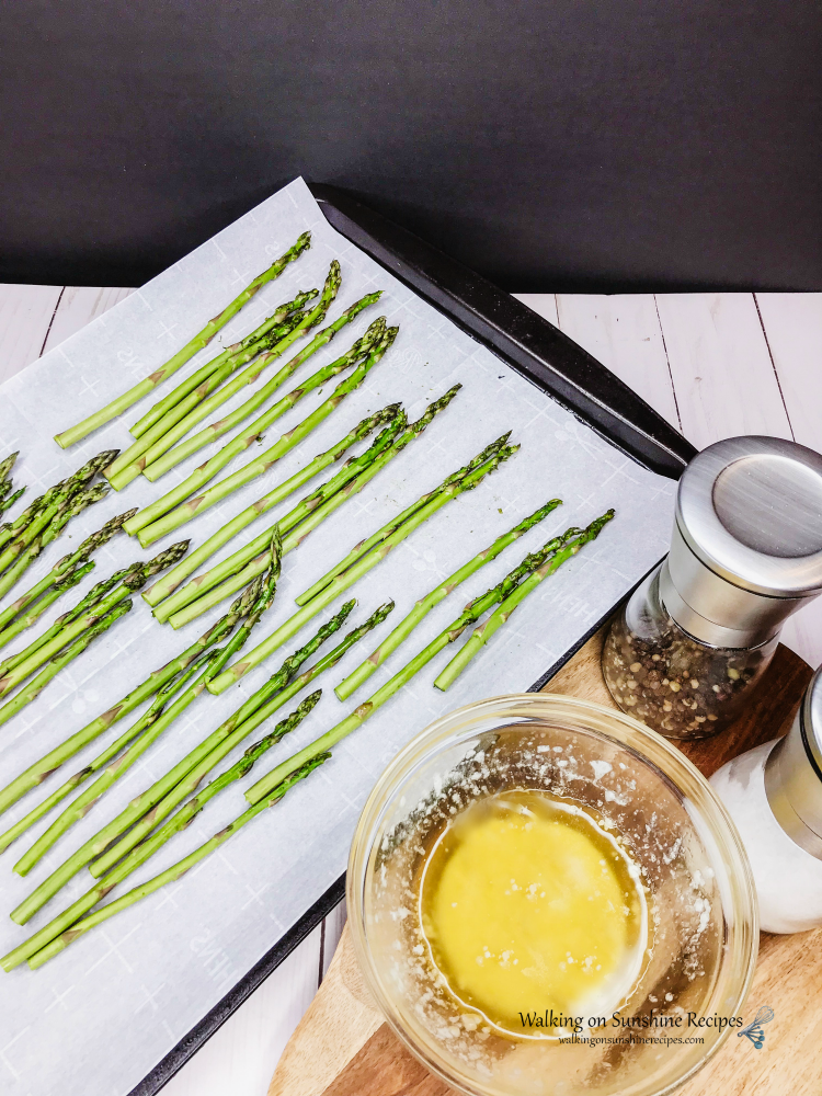 One Pan Chicken and Potatoes. is an easy sheet pan recipe your family is going to love. Crispy chicken with baby red potatoes is perfect for dinner tonight from Walking on Sunshine Recipes. Asparagus on Baking Tray lined with Parchment Paper