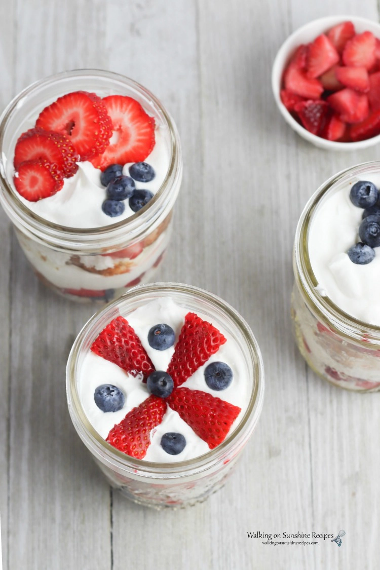 Berry Trifle Recipe in mason jar with strawberries, blueberries and whipped cream