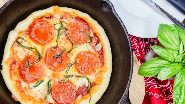 https://walkingonsunshinerecipes.com/wp-content/uploads/2019/06/Cast-Iron-Pan-Pizza-baked-and-ready-to-serve-from-Walking-on-Sunshine-Recipes-720x405.jpg