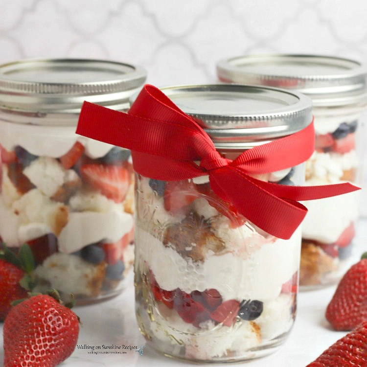 Closeup of Berry Trifle Recipe in Mason Jar with red ribbon 