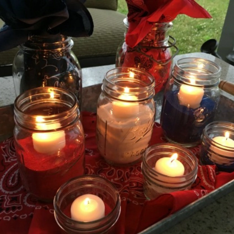 red, white and blue candles in mason jars. 