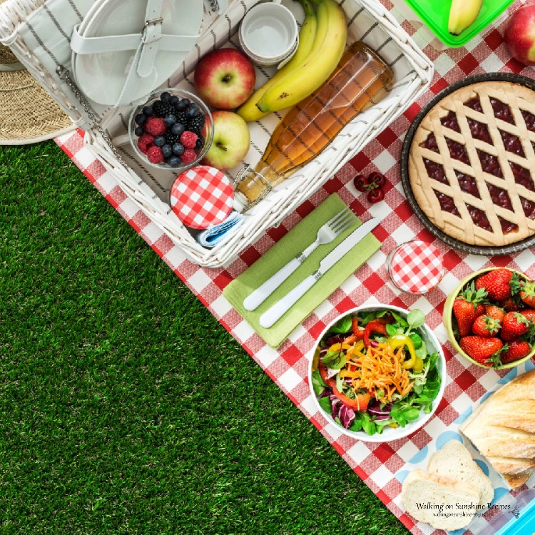 Picnic basket with food on picnic table