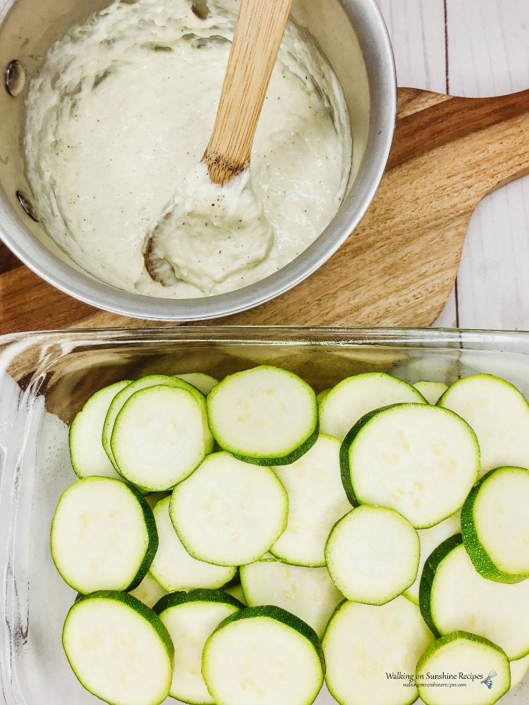 Sliced Zucchini in baking tray ready for cheesy cream sauce 