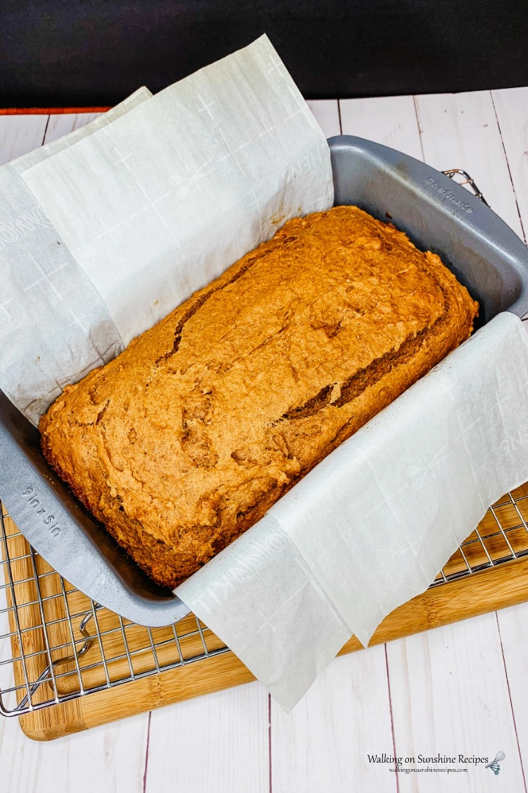 Baked Pumpkin Bread in loaf pan with parchment paper