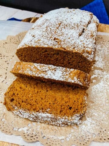2 Ingredient Pumpkin Bread on Cutting Board with powdered sugar