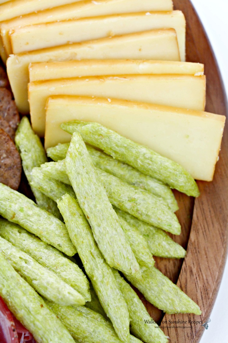 Veggie crackers and cheese on board. 