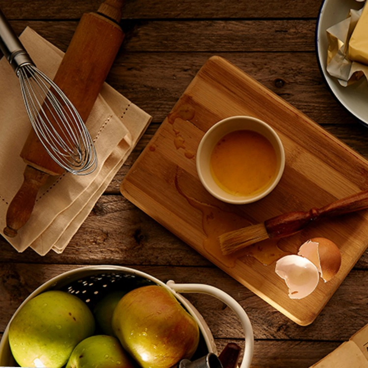 Cutting board with eggs, apples and butter. 