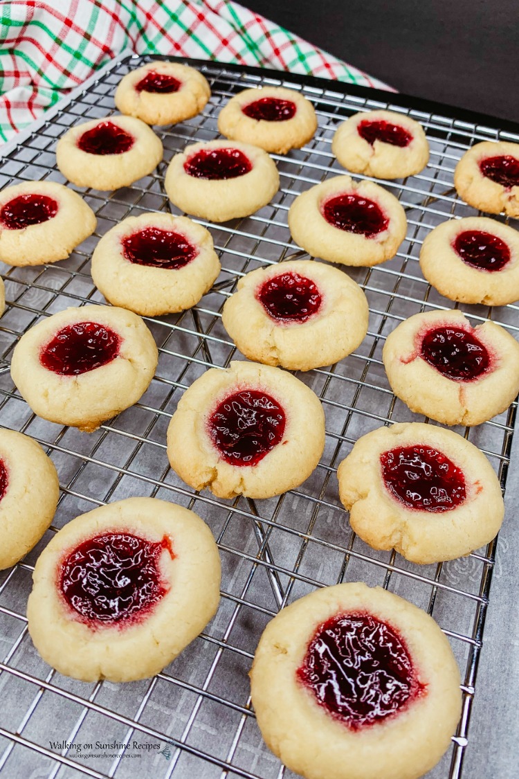 easy raspberry thumbprint cookies baked on cooling racks.