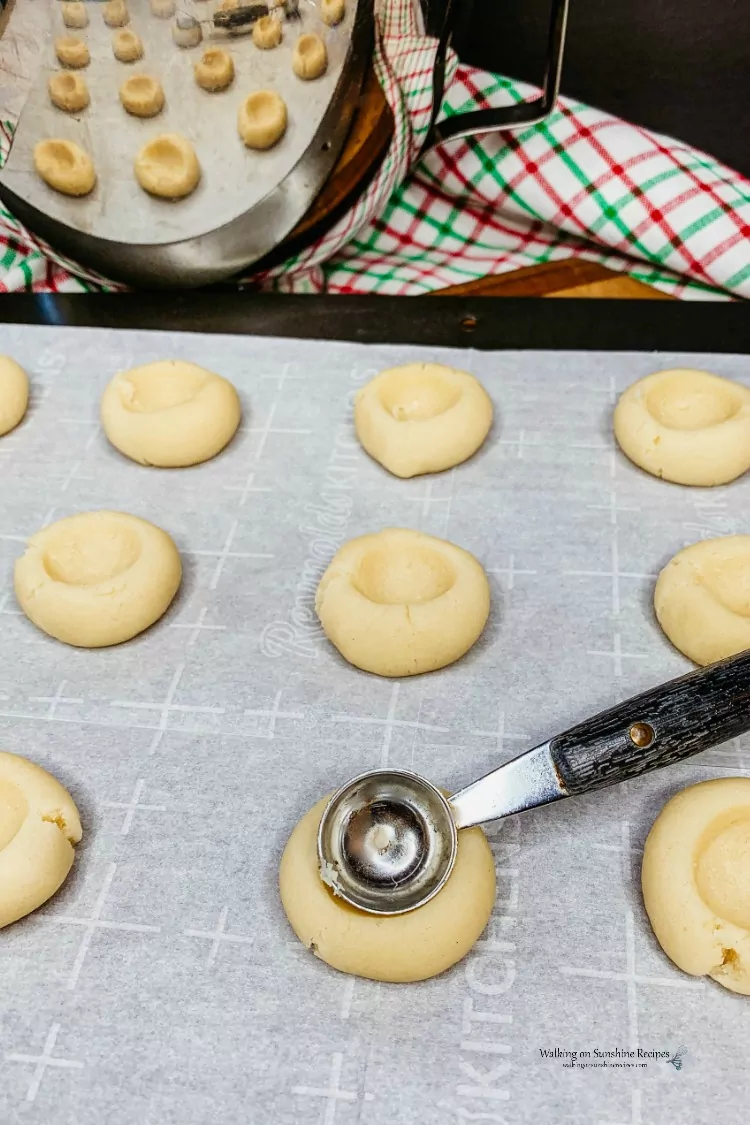 Closeup of Making the Thumbprint Hole in the Shortbread Cookies using a melon ball scoop. 