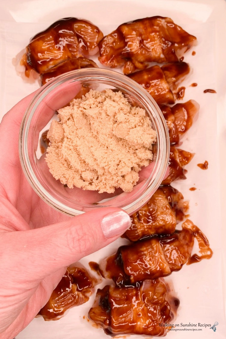 Add brown sugar to the top of bacon wrapped barbecue chicken bites